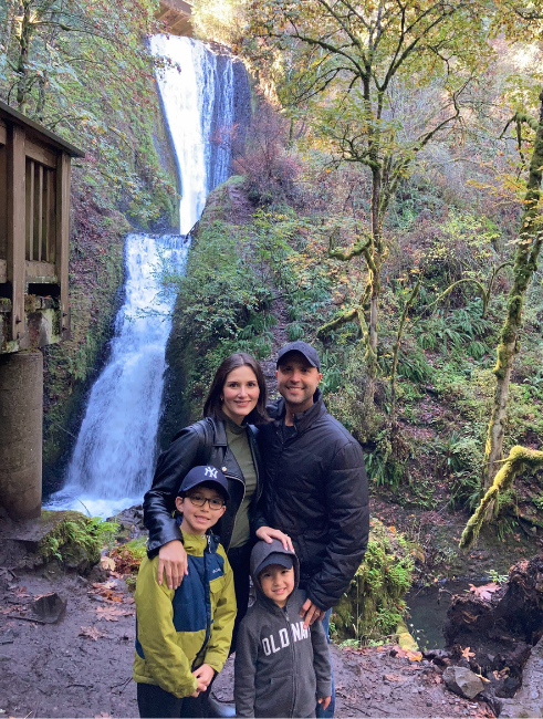 Juan Fernandez and family in front of a waterfall